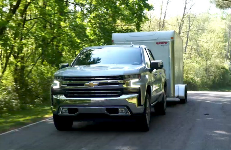 2019 Chevy Silverado towing a trailer on forest road
