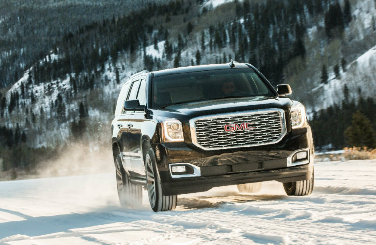 2018 GMC Yukon driving on snow exterior front view